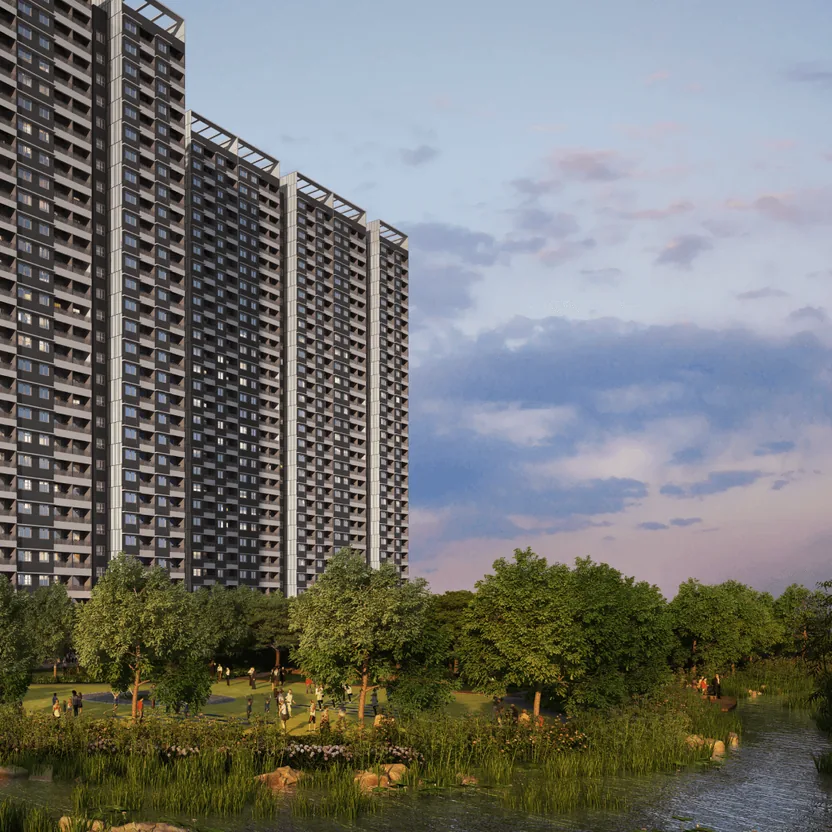 Adarsh Park Heights towers beside a lake and gardens at dusk