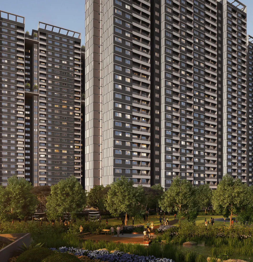 High-rise towers of Adarsh Park Heights above landscaped gardens and a lake at sunset